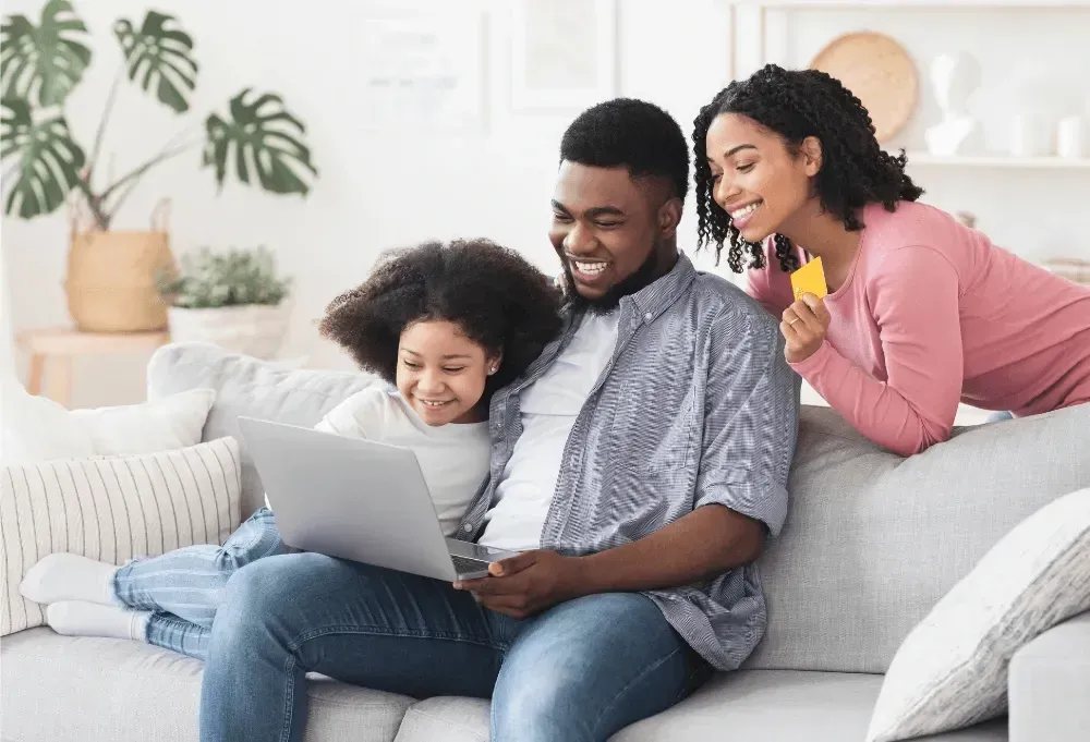 Parents and child reviewing an easy mortgage options online at home.