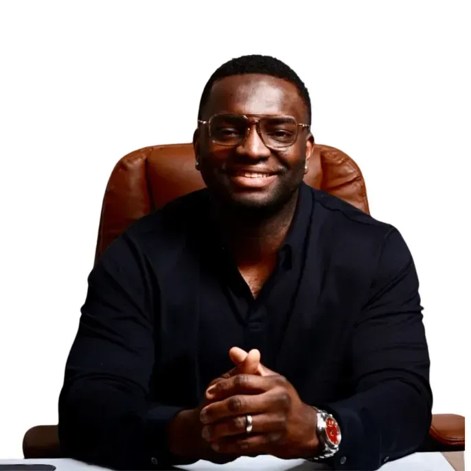 Manny Oloyede, branch manager and mortgage loan officer, smiling professional portrait on personal website