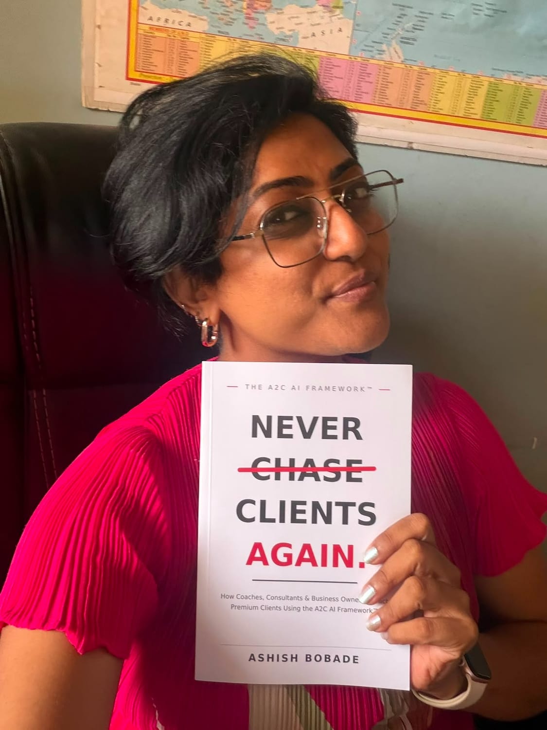 Ashwini Bhavsar with a copy of Never Chase Clients Again