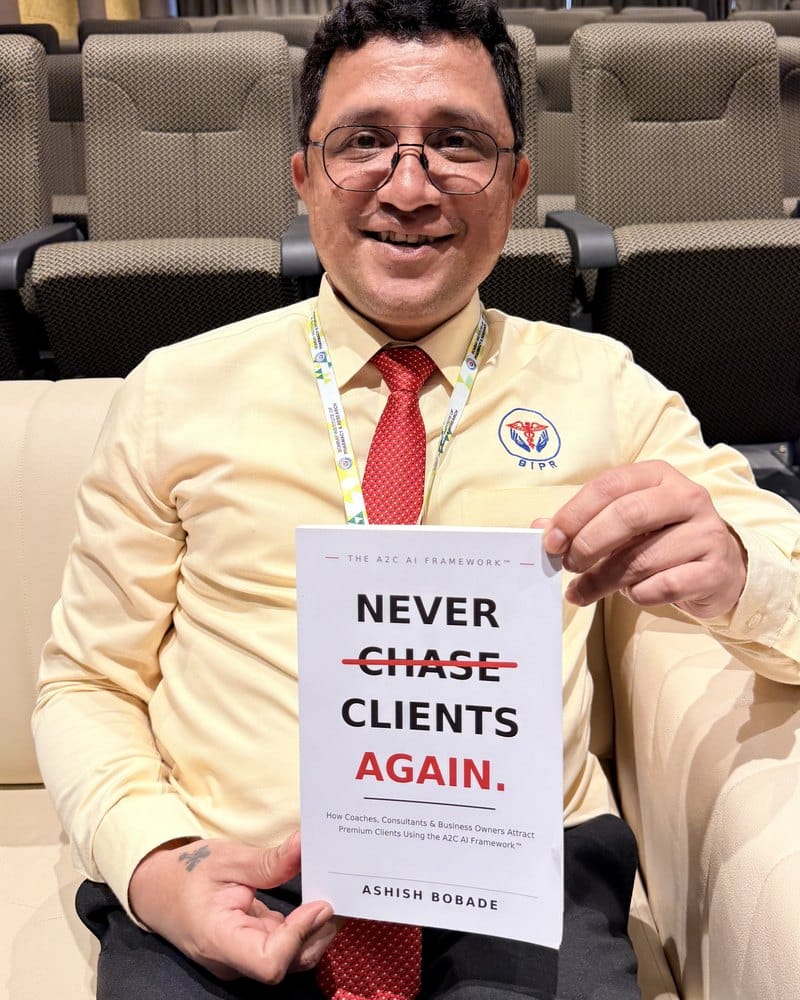 Dr. John I. Disouza with a copy of Never Chase Clients Again