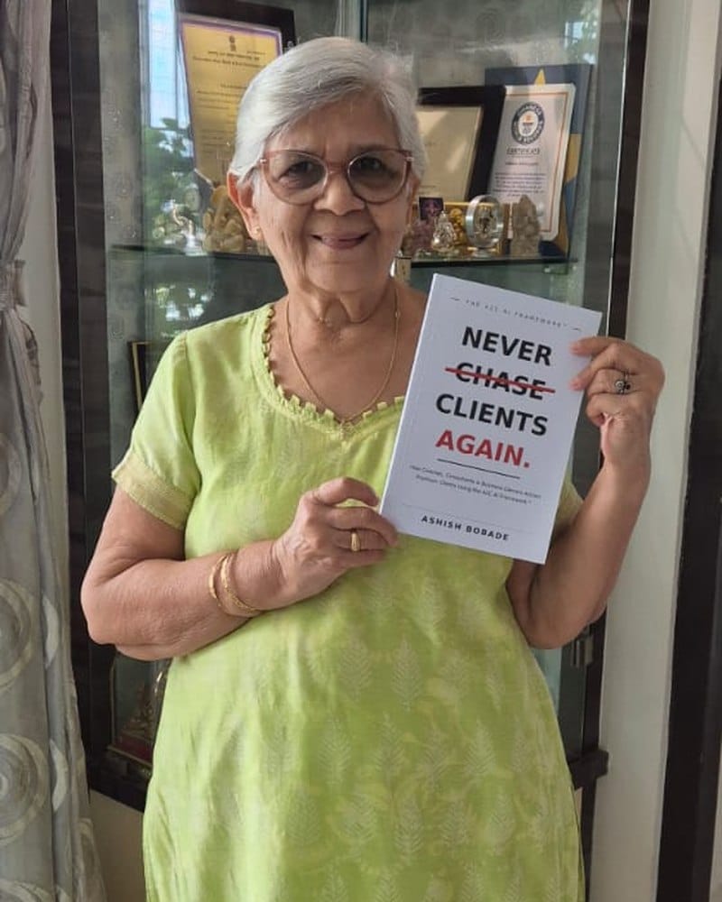 Smt. Radhika M. Gupte with a copy of Never Chase Clients Again