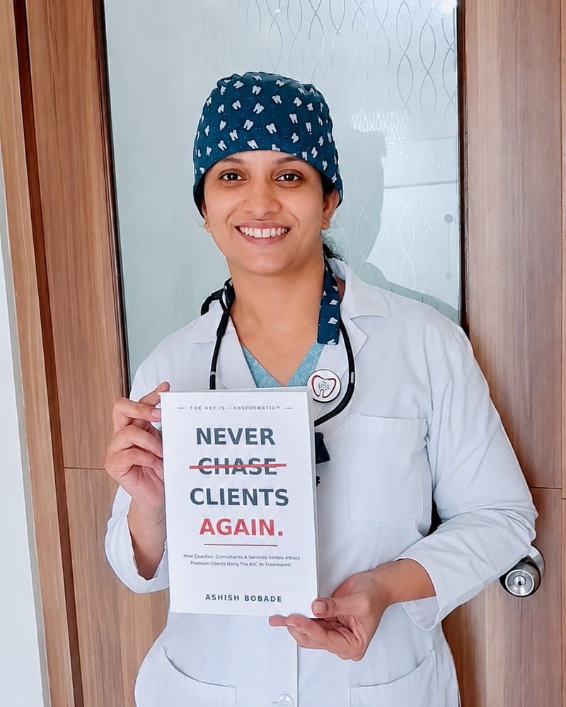 Dr. Bhavya Shetty with a copy of Never Chase Clients Again