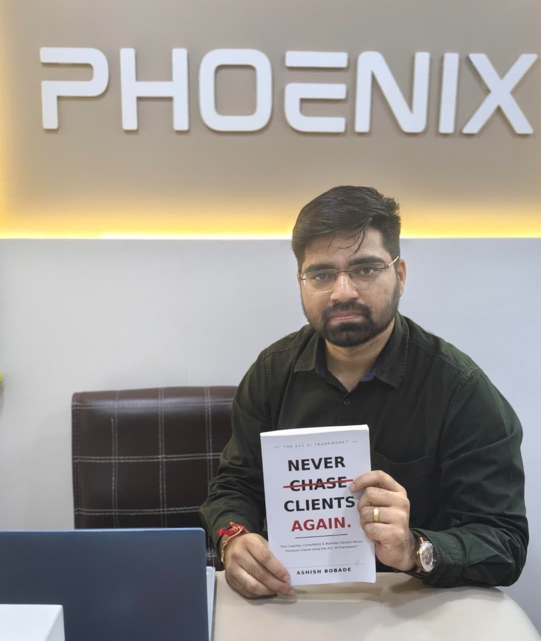 Vishal Saruk with a copy of Never Chase Clients Again
