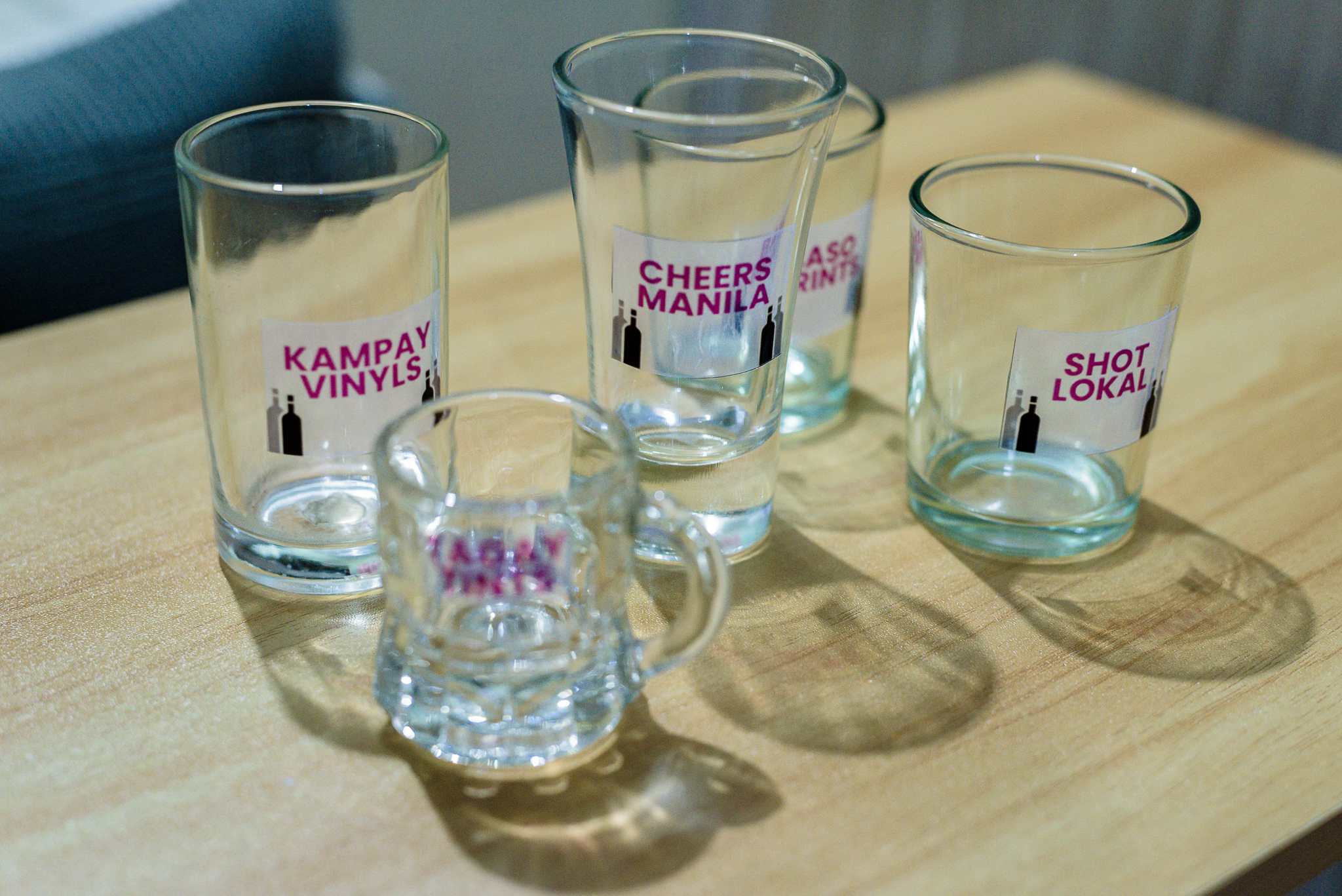a high-definition picture of glasses with semi-clear, semi-transparent stickers on them that has a frosty look and bold, pink texts