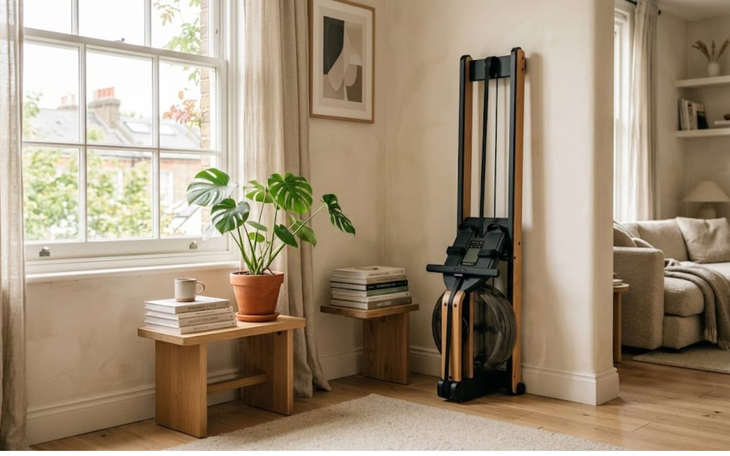 Foldable rowing machine stored upright in a small apartment corner