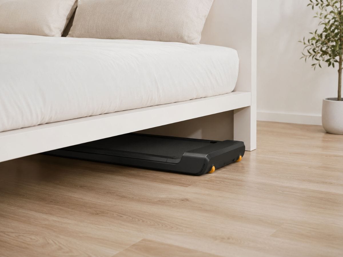 WalkingPad A1 Pro folded and stored under bed in apartment bedroom