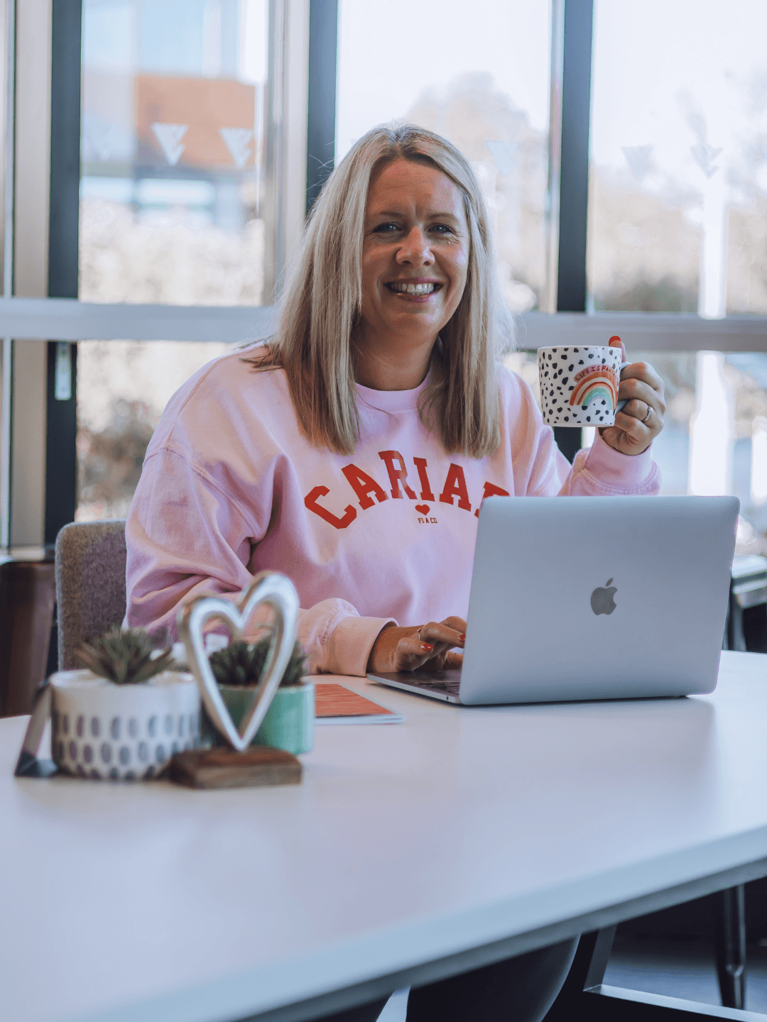 Siriol, founder, sitting with laptop