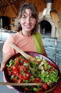 Amy Hartshorn holding a fresh garden salad at Hartshorn Organic Farm farmstand, Waitsfield Vermont