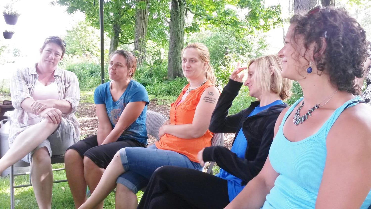 Five participants of Amy Hartshorn's first Vermont wellness retreat seated outdoors in Waitsfield, Vermont