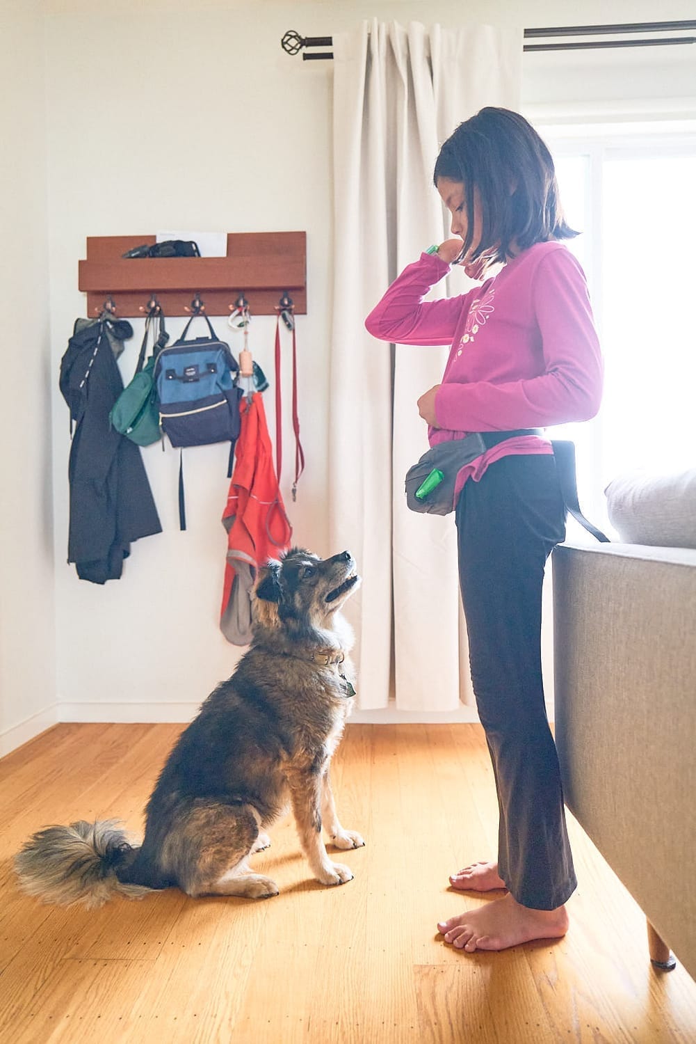 Carys connects with her dog, reflecting empathy, responsibility, and childhood confidence through pet care.