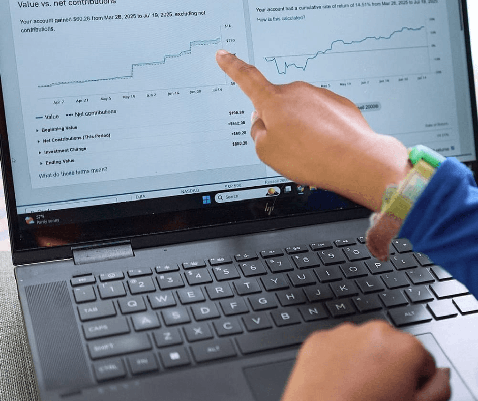 Carys pointing at a graph on her laptop, learning financial literacy and entrepreneurship education skills.