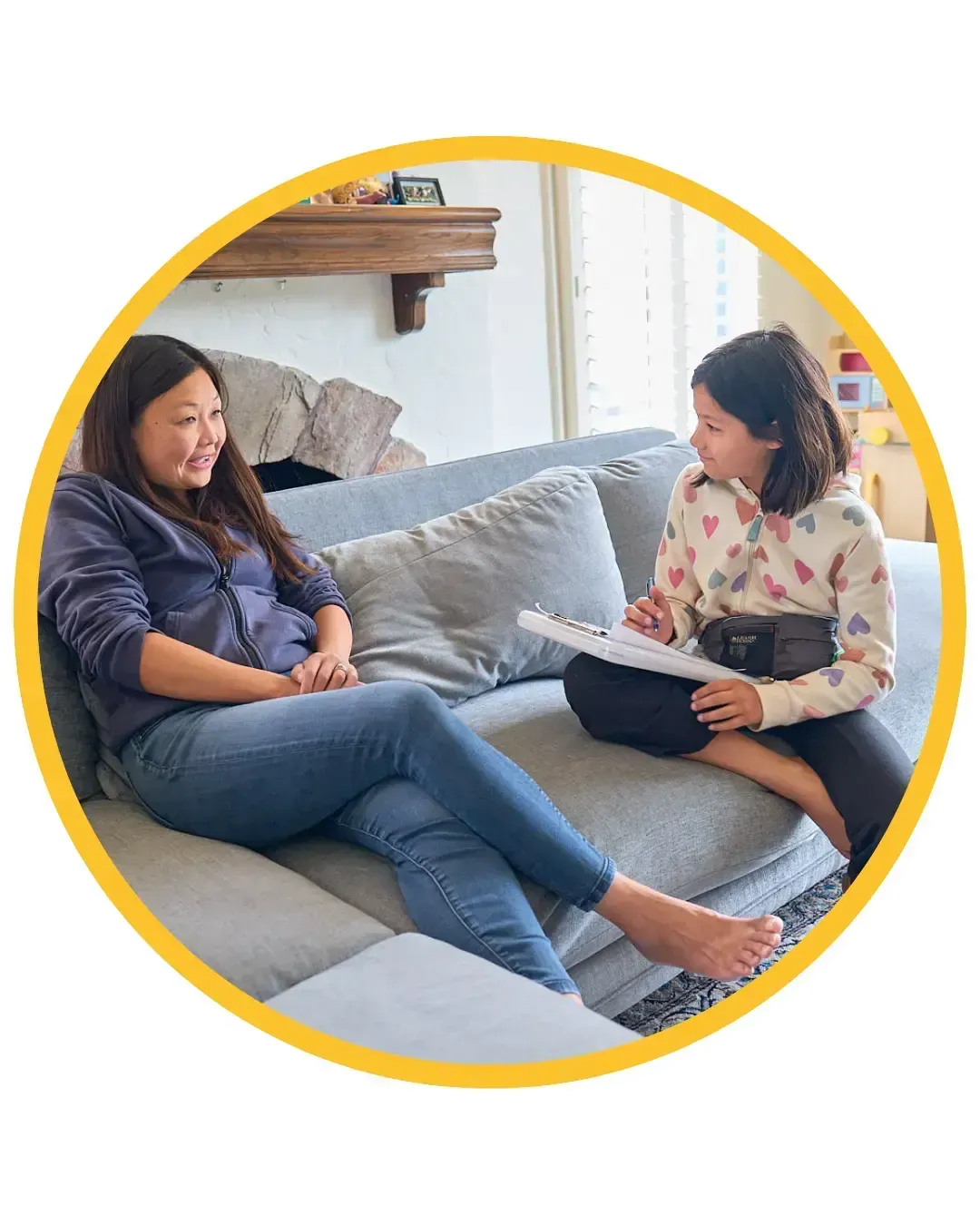 Carys engaged in conversation with a woman, taking notes for a life skills course focused on childhood independence