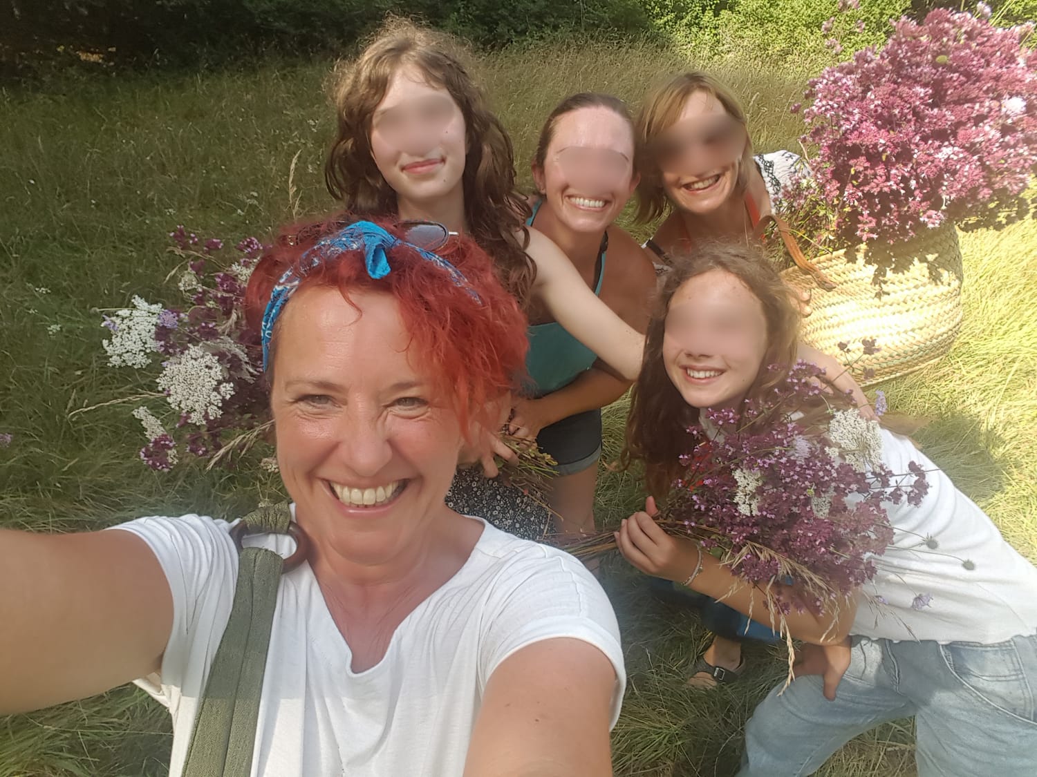 Jenny gathering wild sage with older children during a family holiday in the Dordogne.