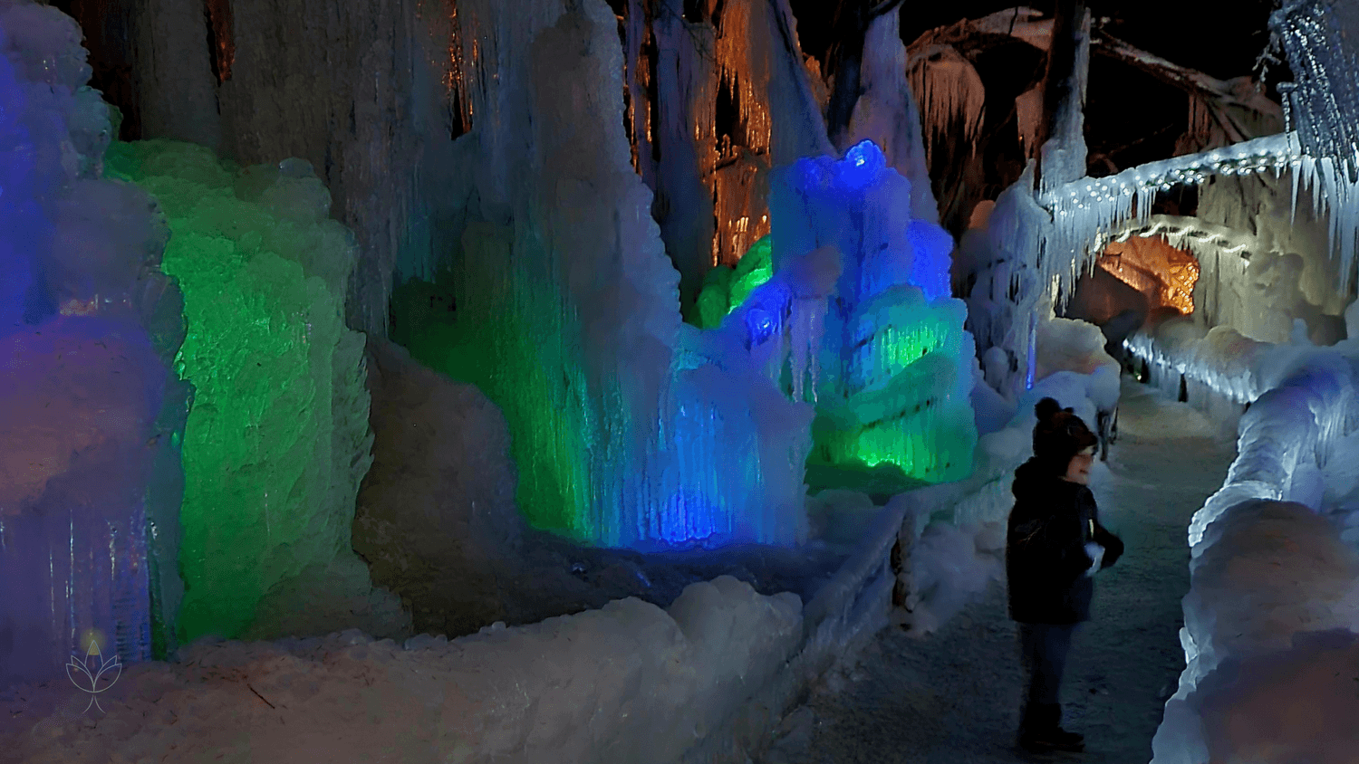 Colorful ice sculptures at Žive jaslice in Mojstrana, Slovenia, creating a magical winter nativity scene.