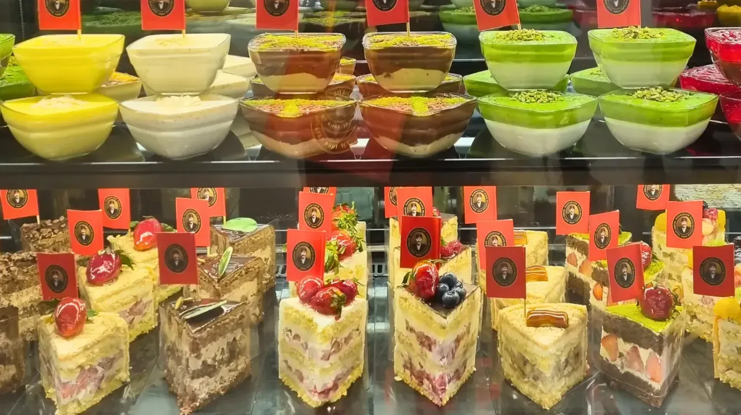 Colorful display of Arabic and international desserts in a Dubai café — showing the city’s rich food culture and daily indulgence.