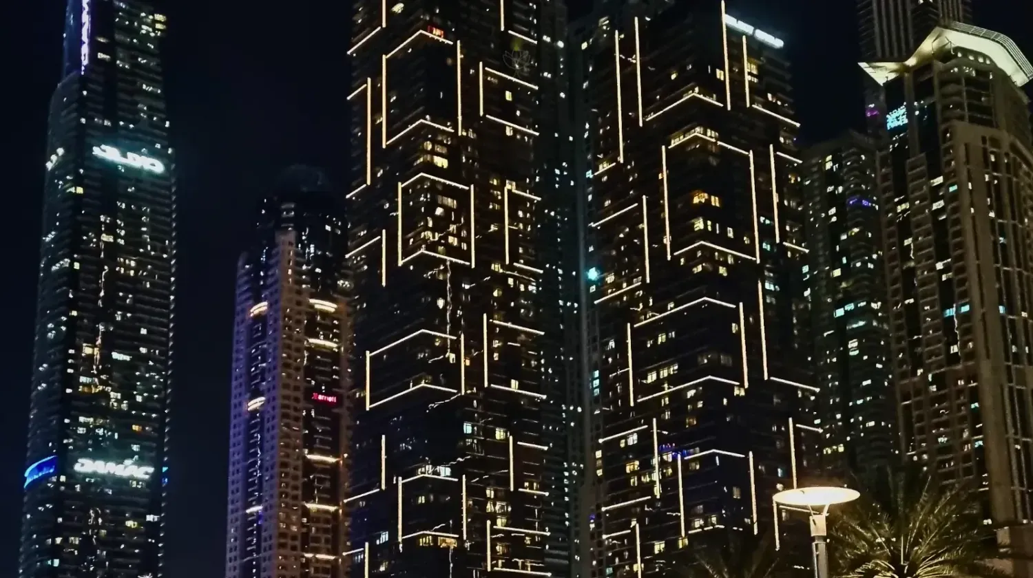 Dubai Marina skyscrapers glowing at night — the vibrant energy and futuristic spirit of the city that never sleeps.