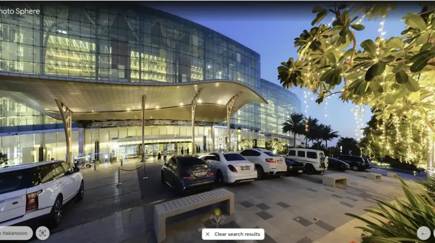 Entrance of Meydan Hotel in Nad Al Sheba, Dubai – modern glass architecture near Meydan Racecourse, symbolizing luxury lifestyle and Free Zone business opportunities.