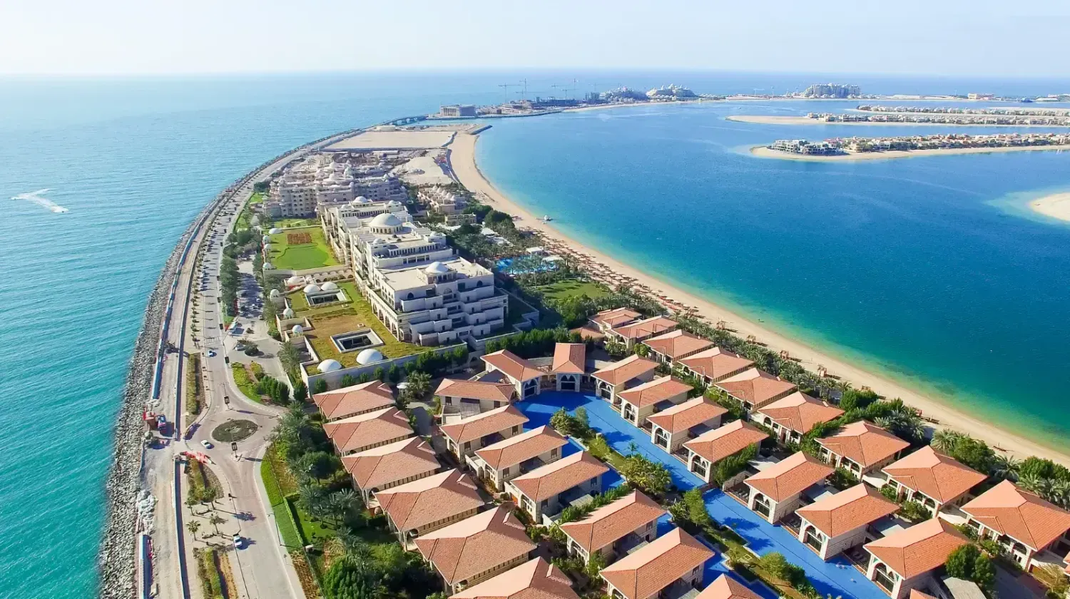 Aerial view of Business Bay and Palm Jumeirah in Dubai — comparison of lifestyle, real estate investment options, and property value differences.