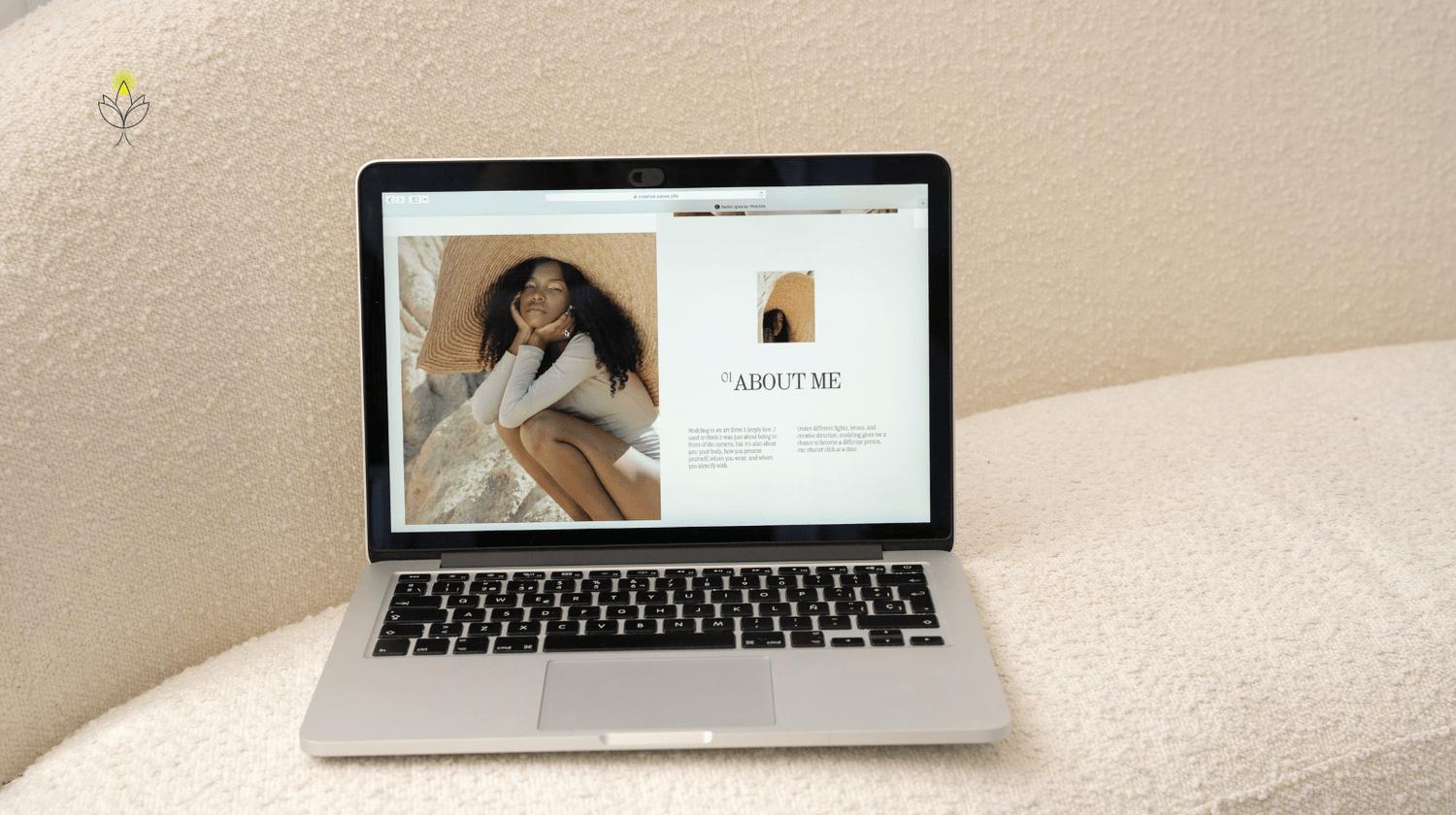 Laptop displaying a minimalist website design on a cream sofa, representing a simple online presence and website system for coaches and experts.