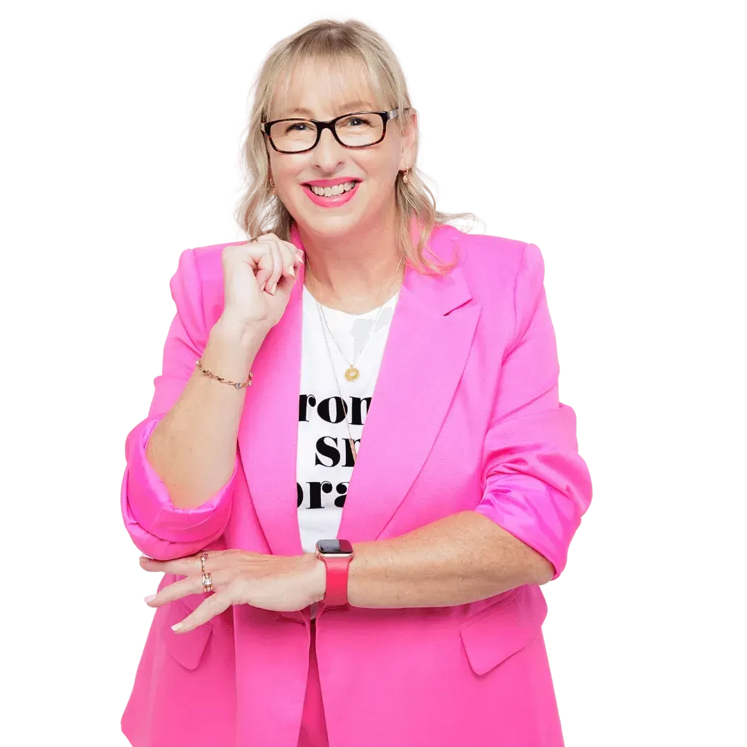 Image of Justine McLean, a woman with long blond hair, wearing black rimmed glasses, smiling at the camera. Justine is the owner of this website.	