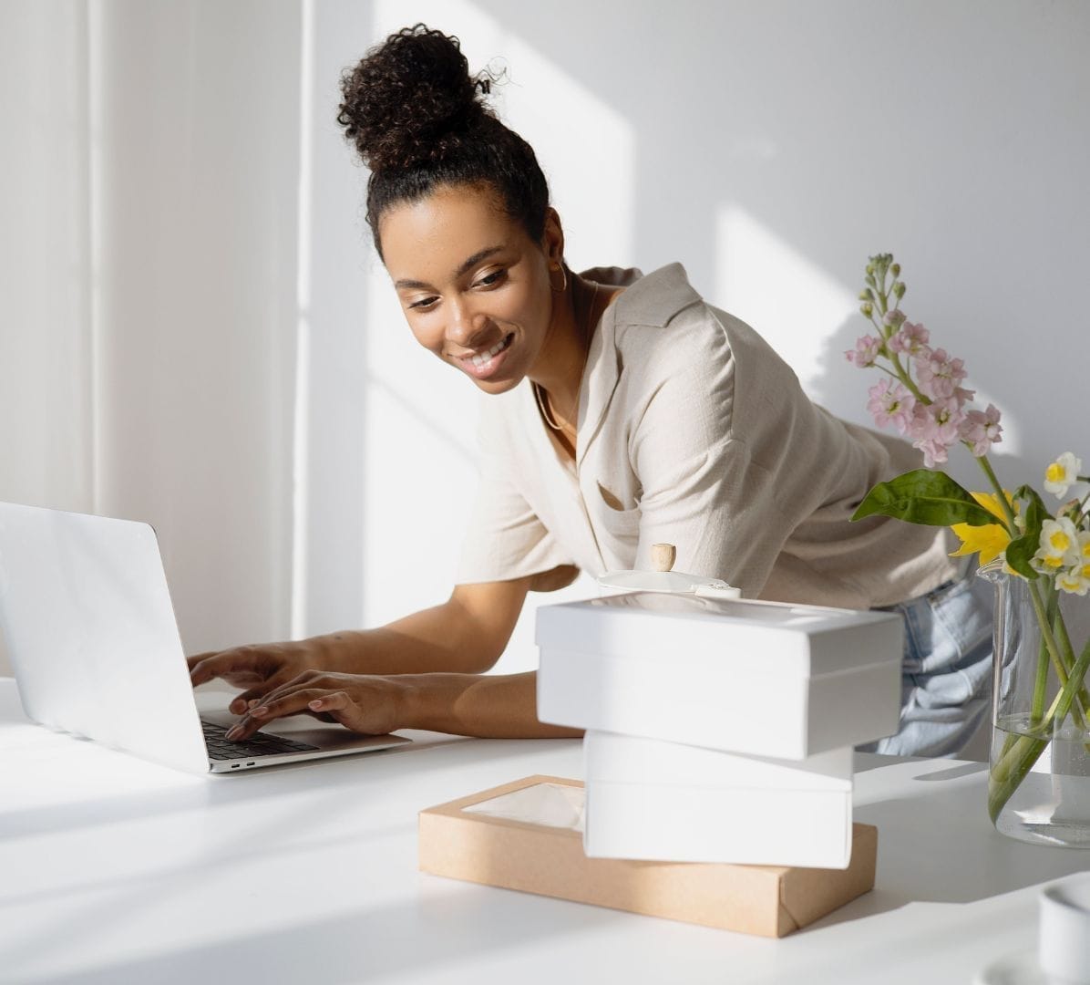 Smiling woman typing on a laptop	