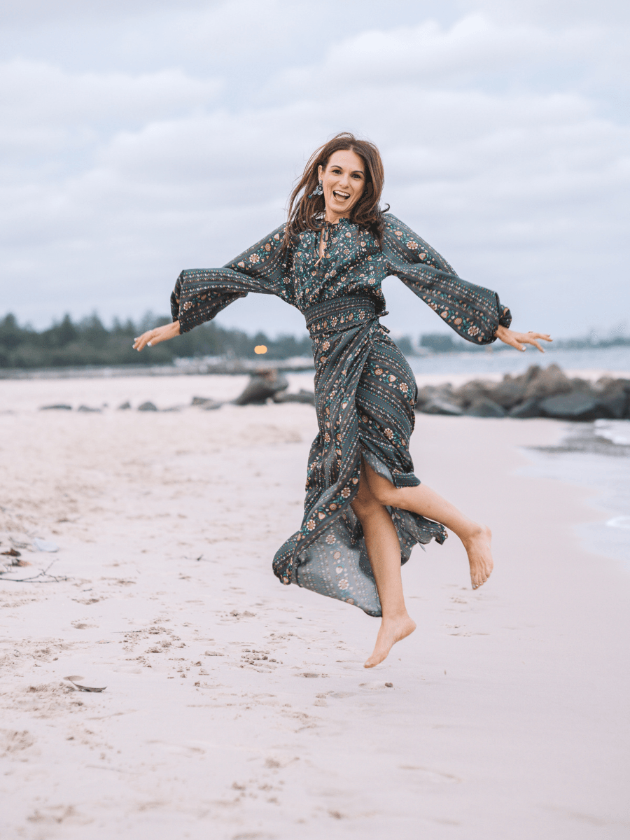 Dora Nikols celebrating a life of purpose, joy and meaningful work on the beach in Sydney.