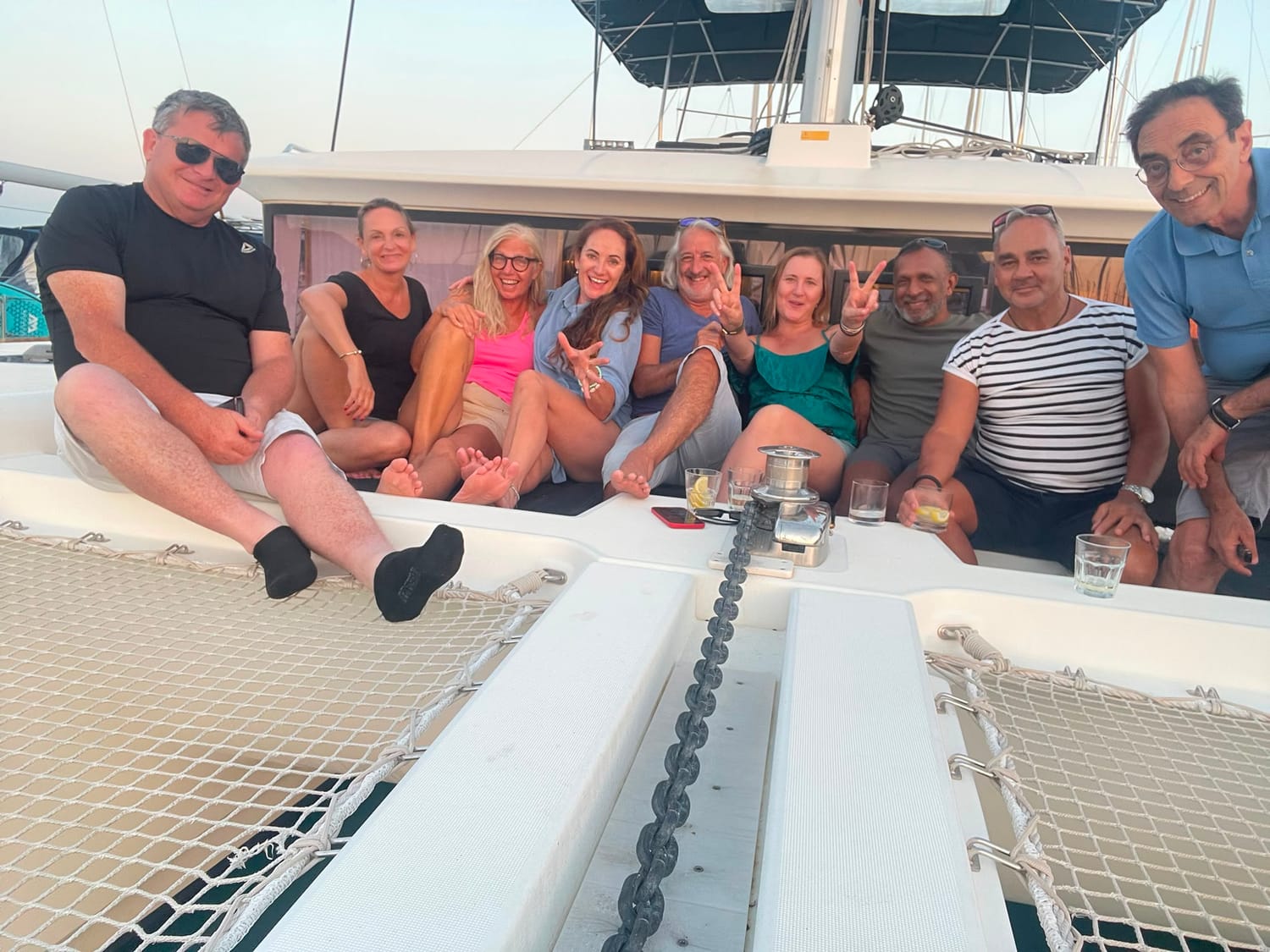 Higher Love Society singles together on the deck of a catamaran