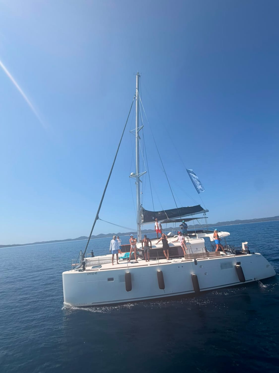 A catamaran under sail with guests on deck