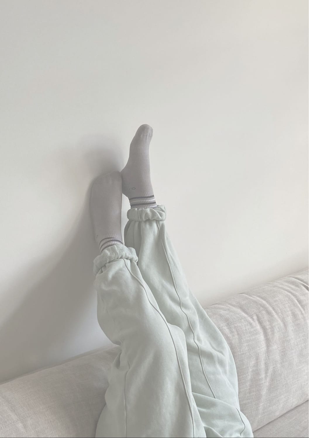 Woman resting with legs up the wall — nervous system regulation for ADHD