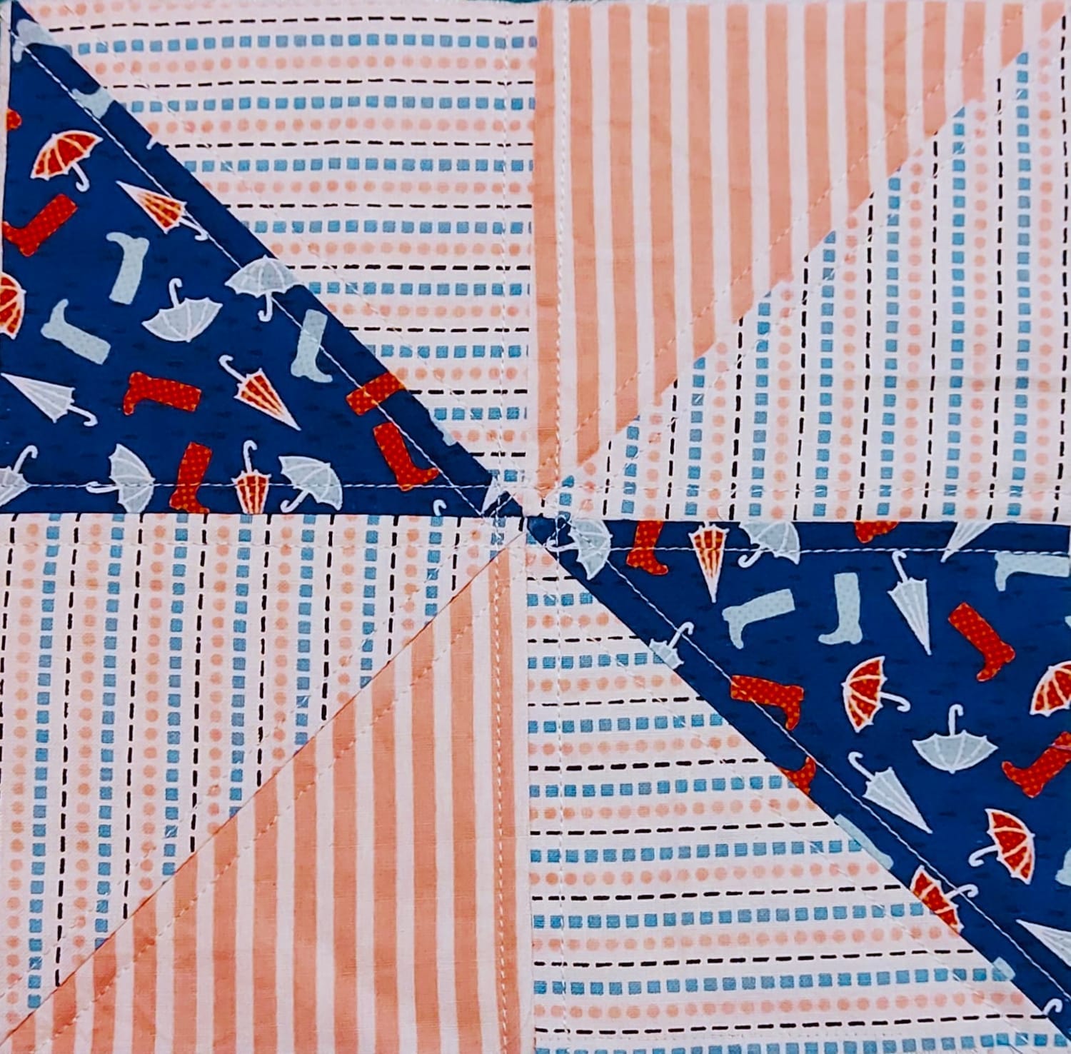 Half Square Triangle quilt block – coral and navy – Quirky Quilt Art.