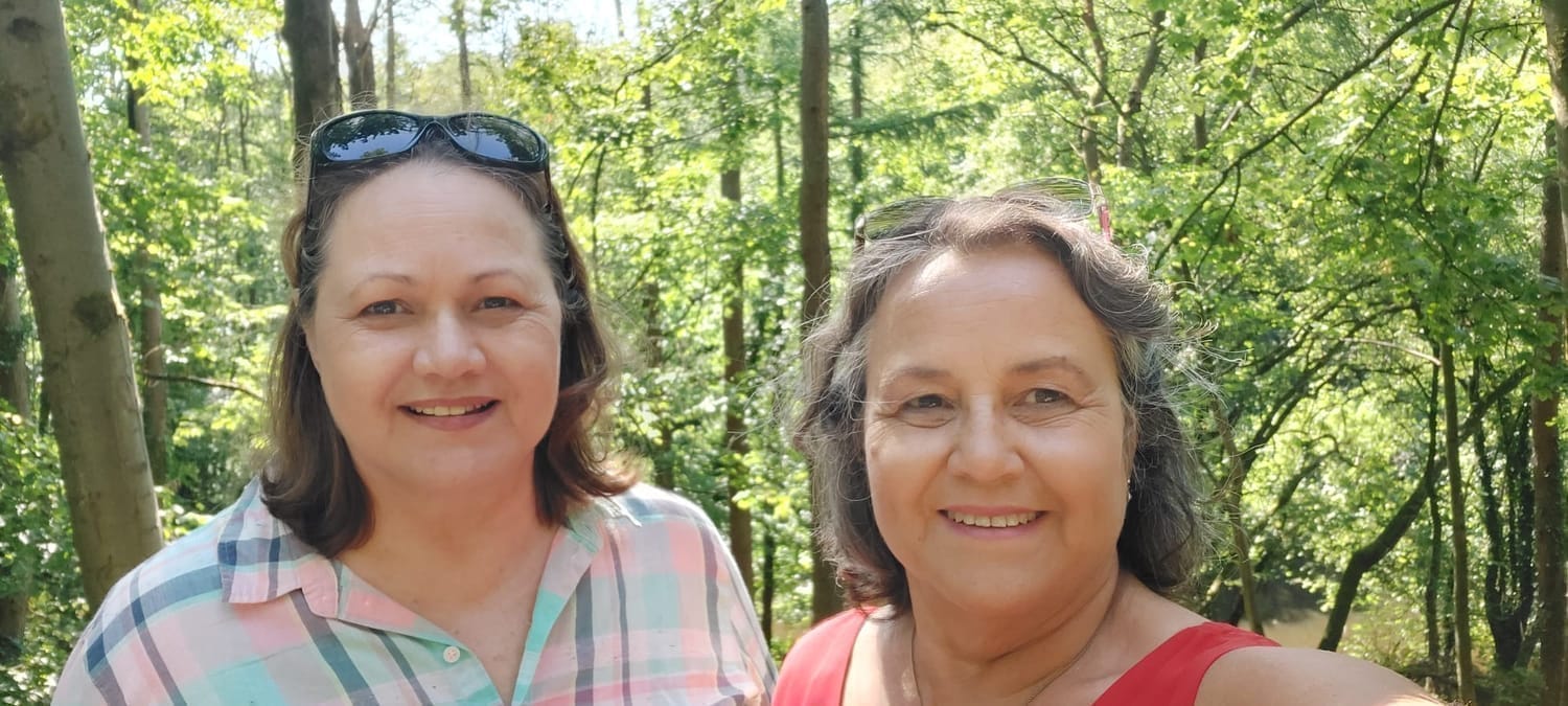 Quirky Quilt Art sisters enjoying a relaxed timeout together in the park, sharing laughter and connection