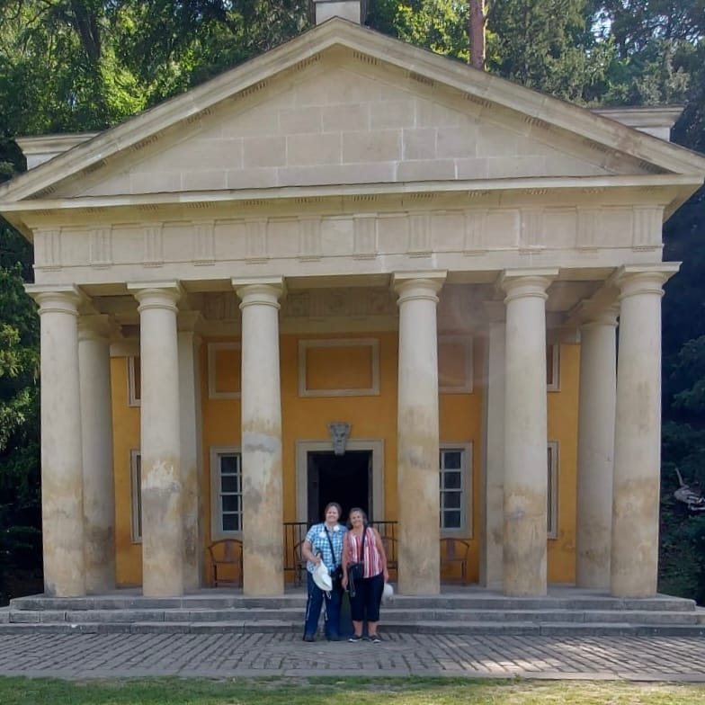 Sisters Elaine and Marlene from Quirky Quilt Art walking through the historic ruins of Fountains Abbey in Yorkshire during their launch weekend celebration.