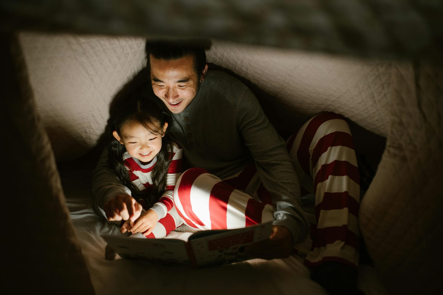 Dad playing with daughter in a made up fort