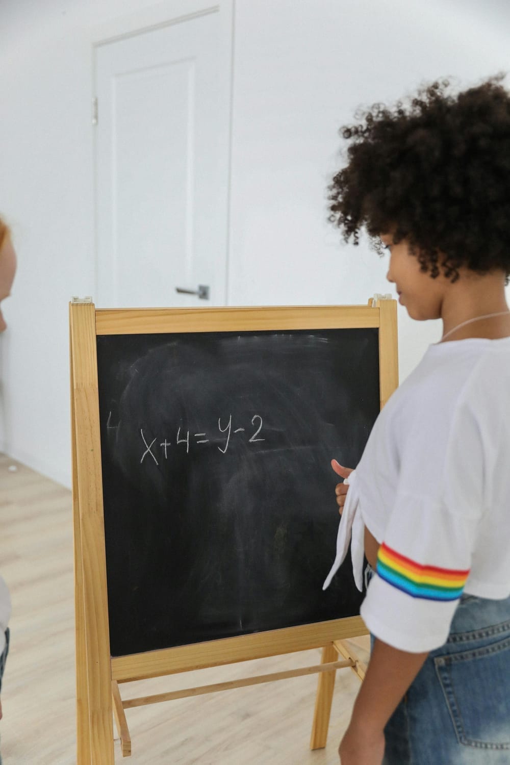 kid doing math on chalkboard