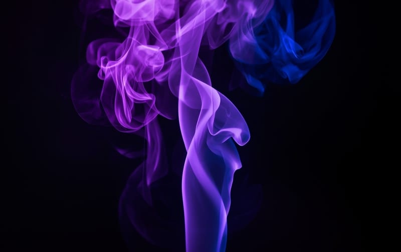 purple and blue smoke swirls rising on black background, mystical, elegant