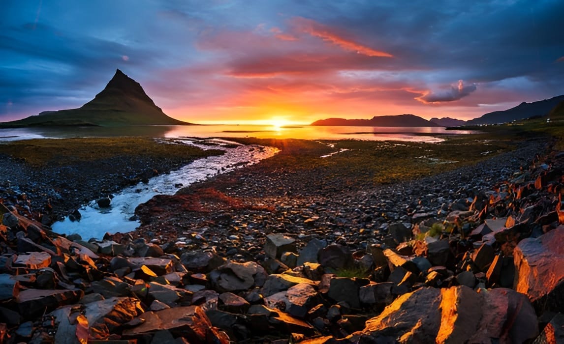 Sunset along Iceland’s rugged coastline near Kirkjufell Mountain, offering expansive views ideal for experiencing the total solar eclipse