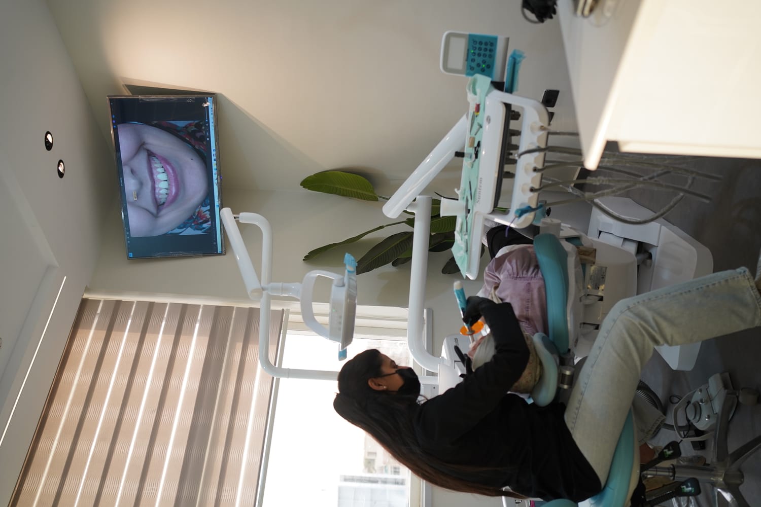 Dr. Amira reviewing smile on screen