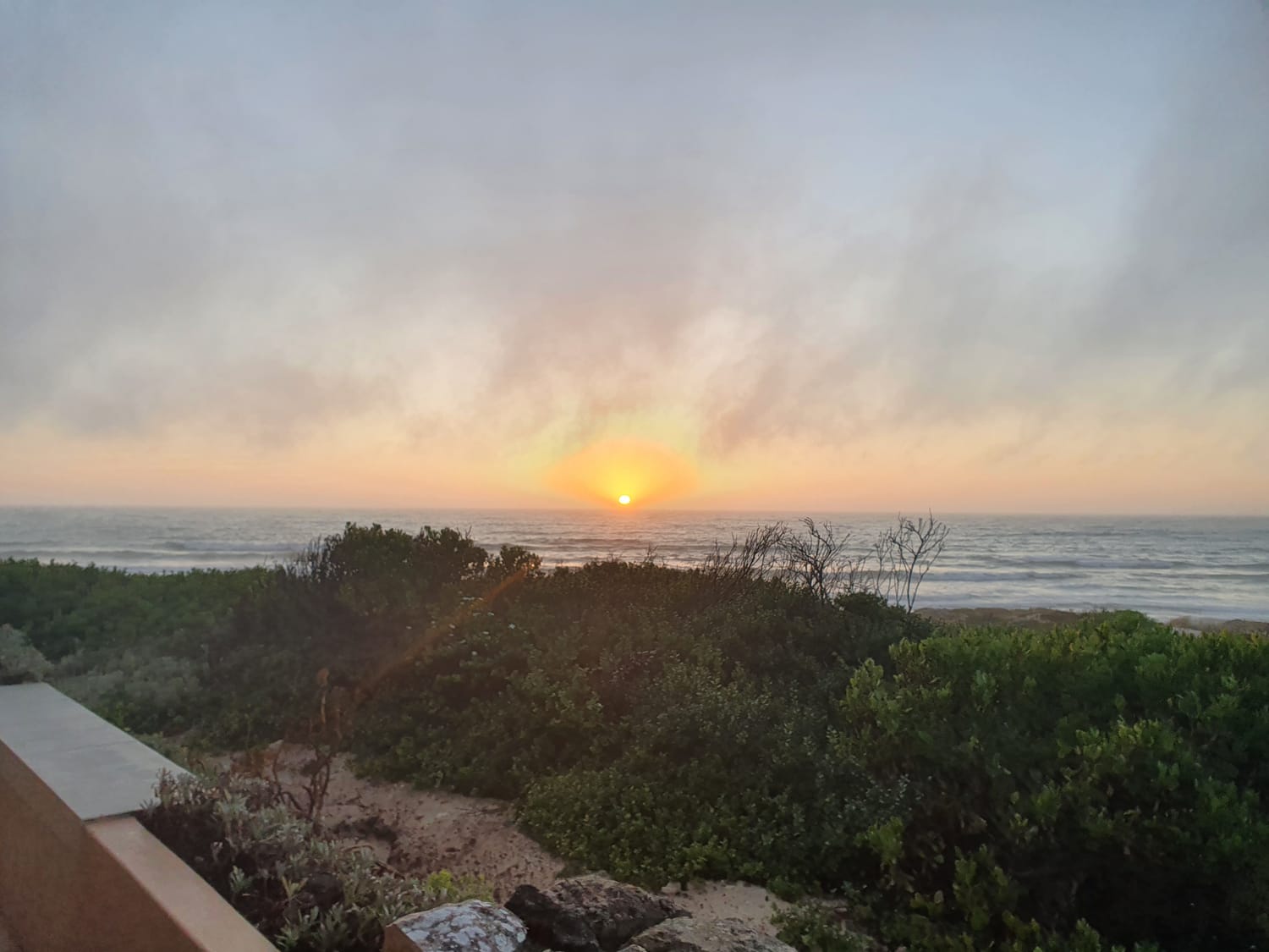 Photo of the sea horizon with the sun rising.