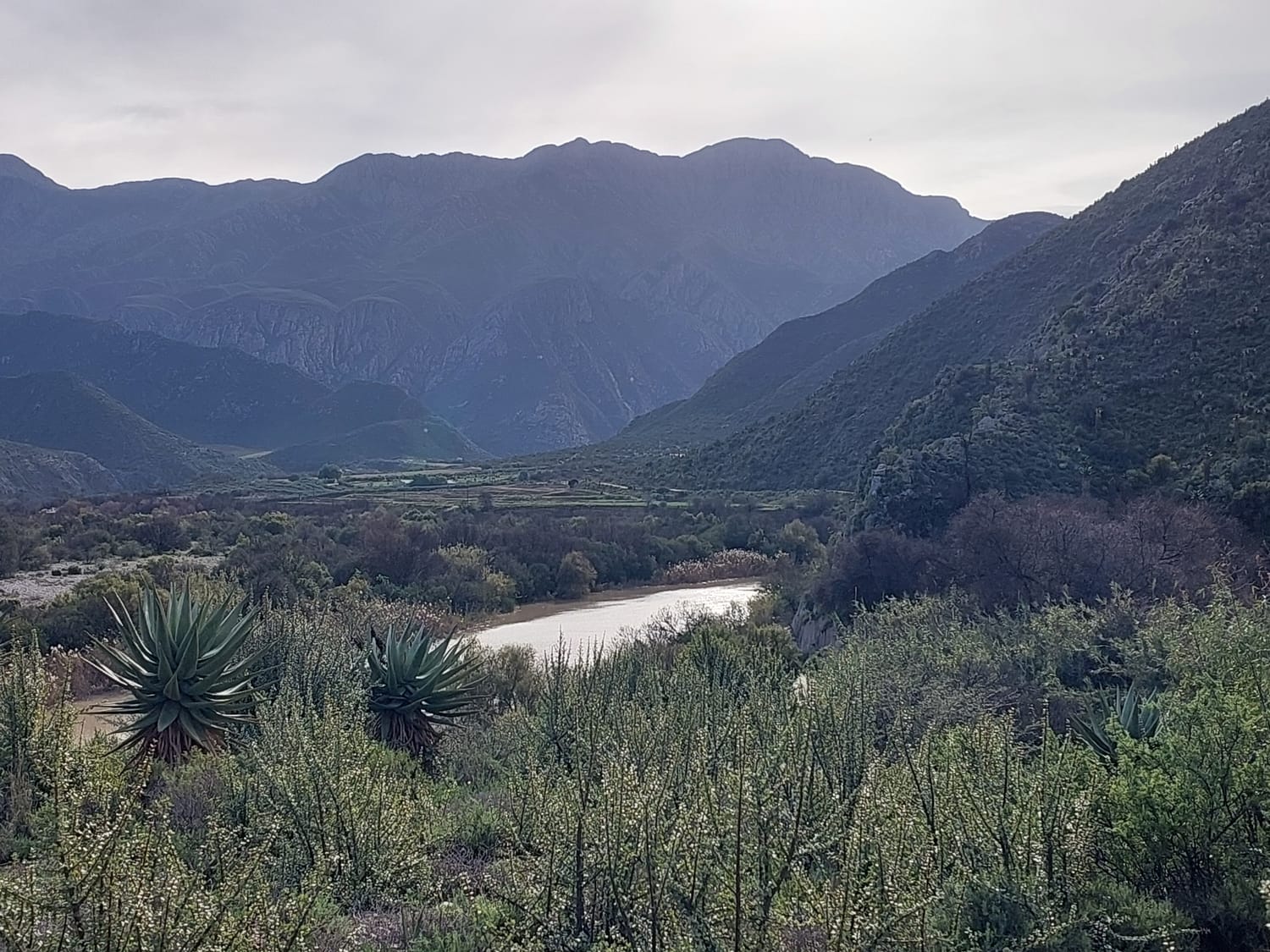 Photo of a valley with mountains on both sides.