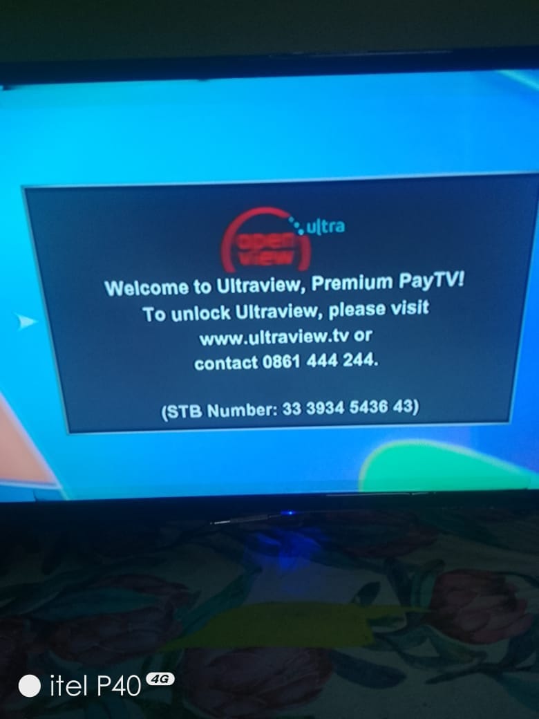 A TV screen displaying a message for Openview Ultra, reading "Welcome to Ultraview, Premium PayTV! To unlock Ultraview, please visit www.ultraview.tv or contact 0861 444 244." with an STB Number.