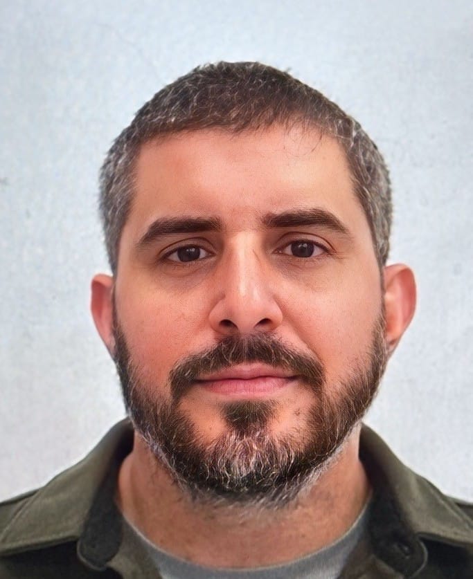Headshot of David S., a satisfied client from Oakland, CA, smiling warmly at the camera with dark hair and beard, providing a testimonial about how Fabiola's pet care services helped his anxious cat feel comfortable and engaged during visits.