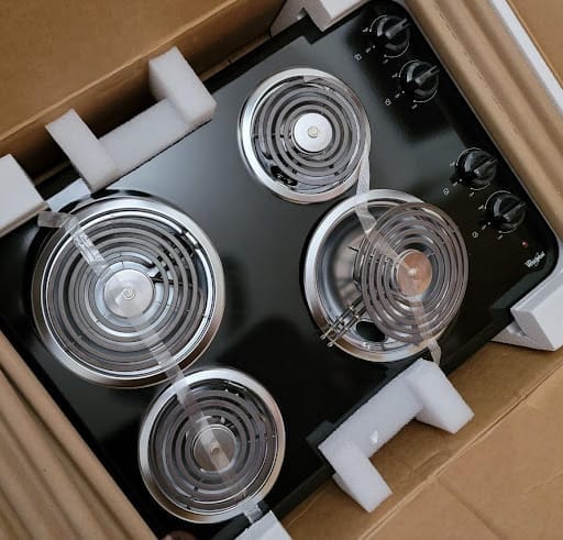 Black refrigerator and wine cooler beside stainless dishwasher