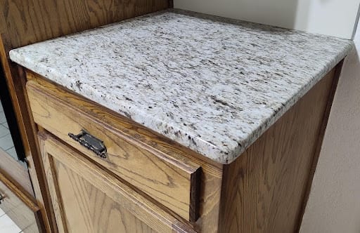 Kitchen before remodel with laminate counters and 11.5″ bar overhang