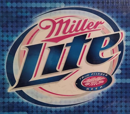 Black refrigerator and wine cooler beside stainless dishwasher