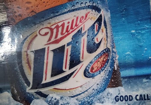 Black refrigerator and wine cooler beside stainless dishwasher