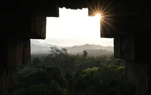 An image overlooking the jungle from a temple window. The temple window looks like a Chakana. Credit goes to Joshua Kettle