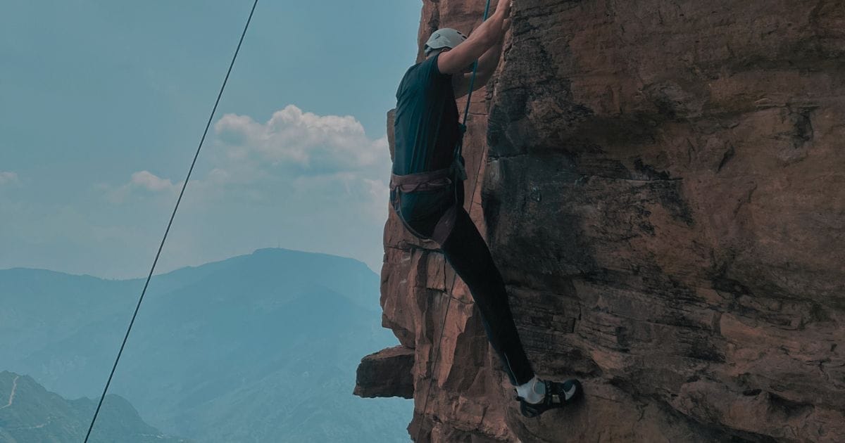 Man rockclimbing and pushing his limits in the wild