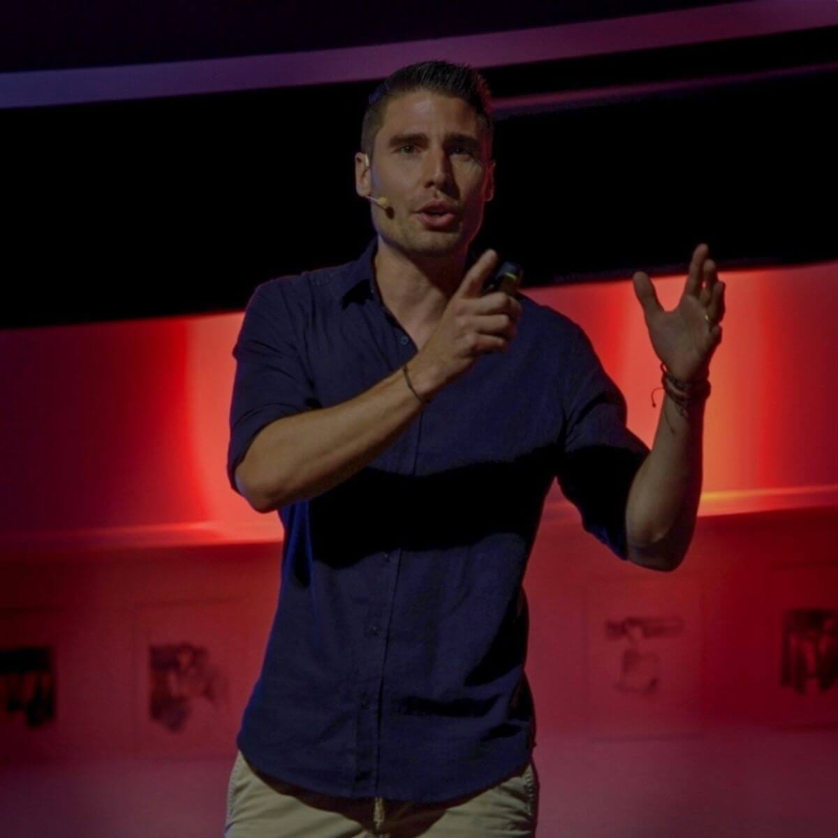 Francois de Neuville speaking on stage