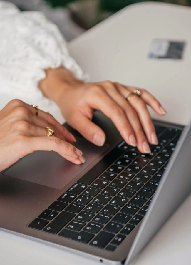 woman typing on laptop