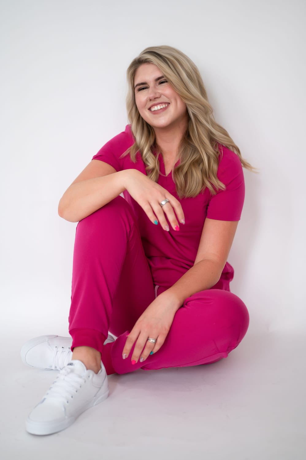 Burnout Coach Mary wearing pink scrubs